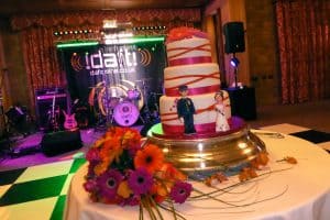 Wedding cake with wedding band logo in the background