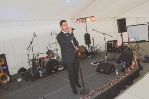 Singer Joe Fryd performing at a VIth form ball